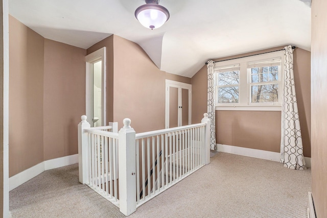 bonus room featuring vaulted ceiling, carpet flooring, and baseboards