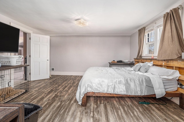 bedroom featuring visible vents, wood finished floors, and baseboards