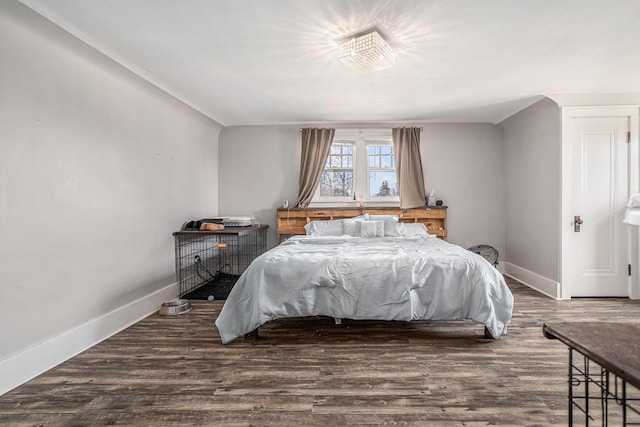 bedroom featuring baseboards and wood finished floors