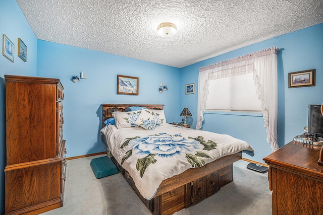 bedroom with baseboards, carpet floors, and a textured ceiling