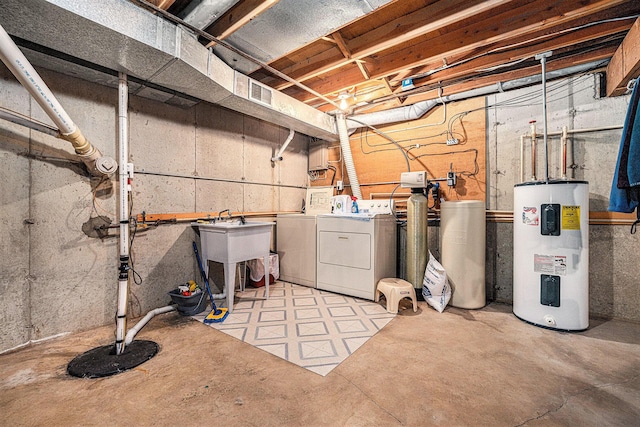 unfinished basement with electric water heater and washing machine and clothes dryer