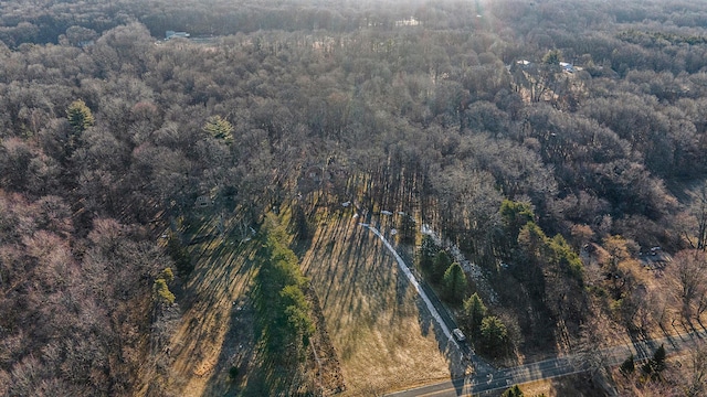 birds eye view of property with a view of trees