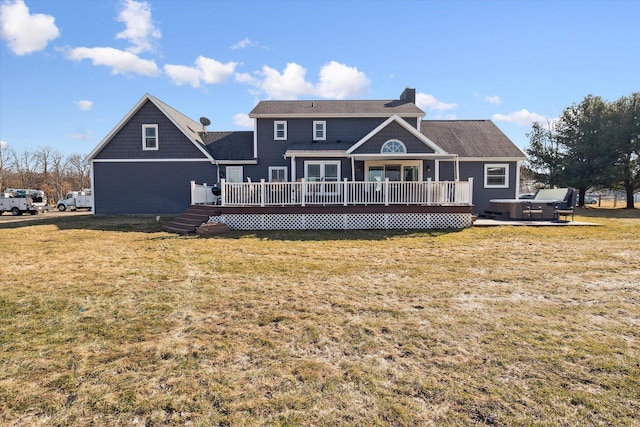 rear view of house featuring a deck, a chimney, and a yard