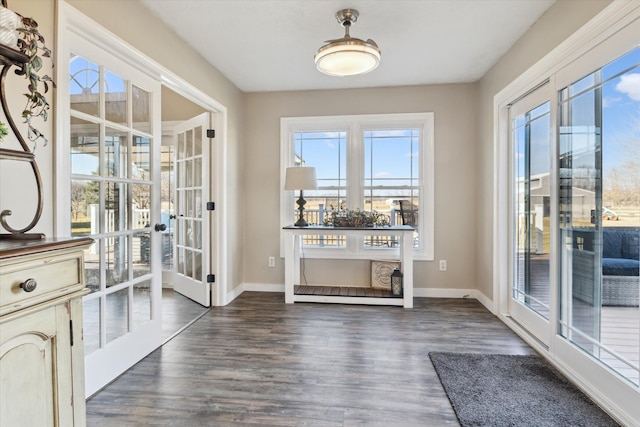 doorway to outside featuring dark wood-style floors, french doors, and baseboards