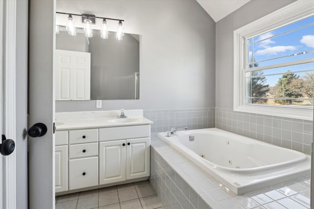 bathroom featuring vanity, a whirlpool tub, and tile patterned flooring