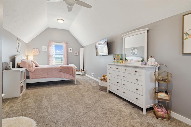 bedroom featuring light colored carpet, baseboards, lofted ceiling, and ceiling fan