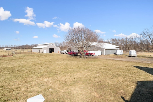 view of yard with an outbuilding, an outdoor structure, and fence