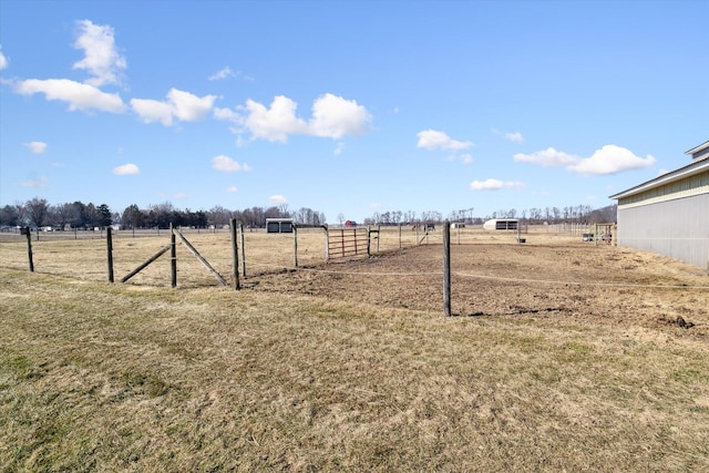 view of yard with a rural view and fence