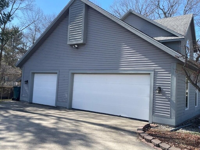 view of side of property featuring roof with shingles