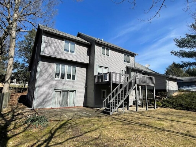 back of house featuring a patio area, stairway, a yard, and a deck