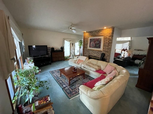 living room with carpet floors, a textured ceiling, ceiling fan, and a fireplace