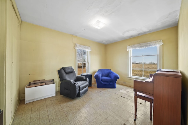 living area featuring tile patterned floors and baseboards