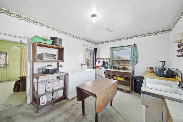 office with concrete flooring and a sink