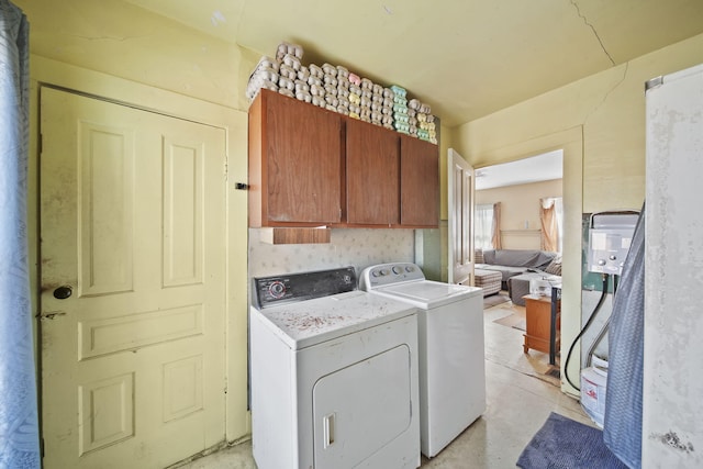 washroom with cabinet space and washing machine and clothes dryer