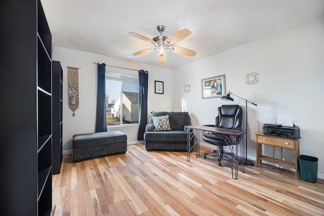 home office featuring ceiling fan, baseboards, and light wood-style flooring