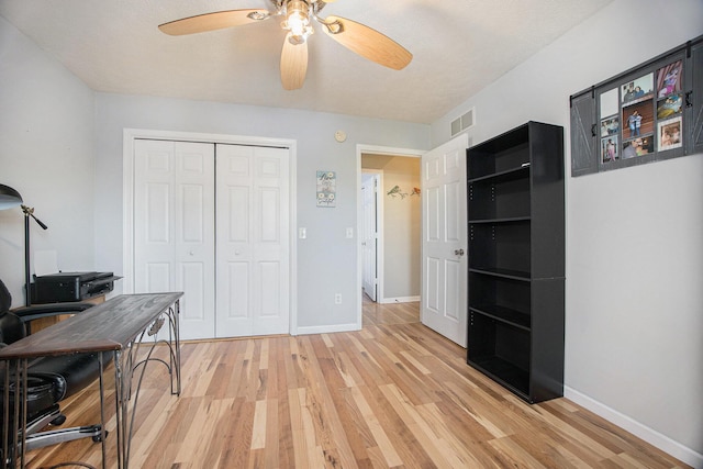 office area with light wood finished floors, baseboards, and ceiling fan