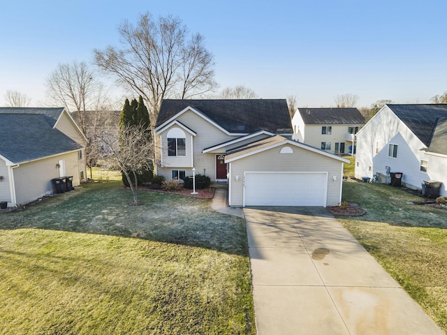 view of front of home with a front yard, an attached garage, and driveway