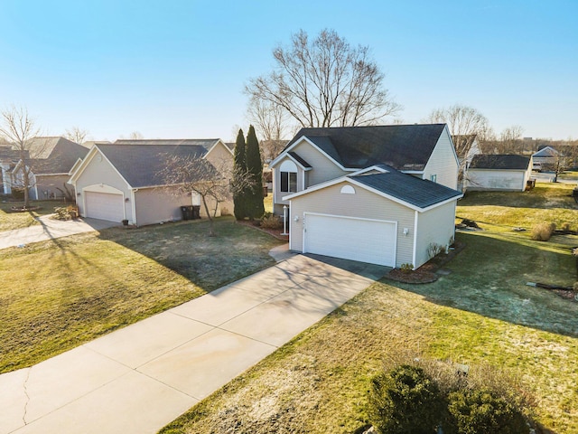 traditional home featuring a front lawn, an attached garage, and driveway