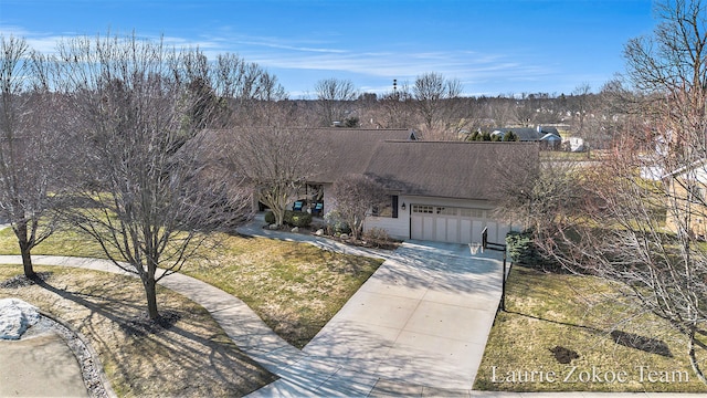 view of front of house with a front lawn, an attached garage, concrete driveway, and roof with shingles