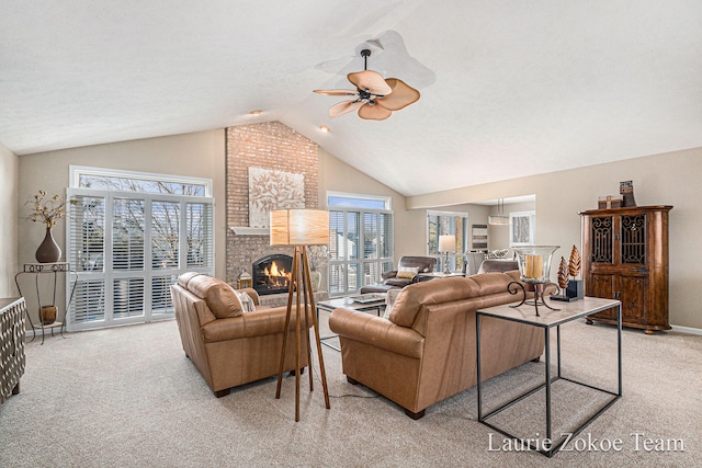 carpeted living room with baseboards, ceiling fan, a fireplace, and vaulted ceiling