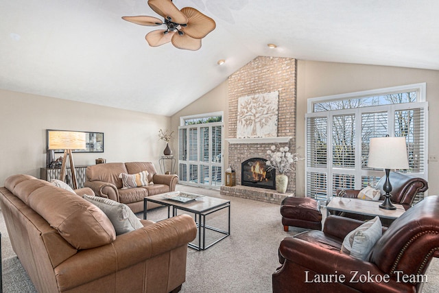 carpeted living area featuring a wealth of natural light, a brick fireplace, lofted ceiling, and ceiling fan