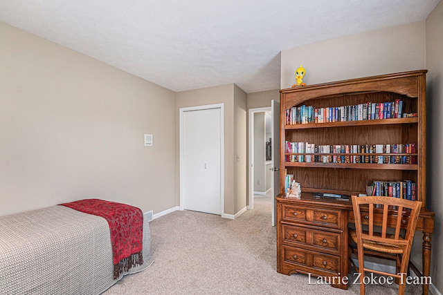 carpeted bedroom featuring baseboards