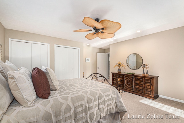 carpeted bedroom with a ceiling fan, recessed lighting, baseboards, and multiple closets