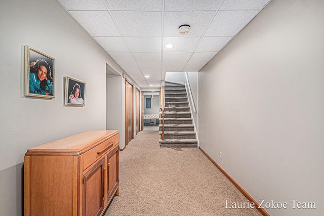 hall featuring light carpet, recessed lighting, stairway, a paneled ceiling, and baseboards