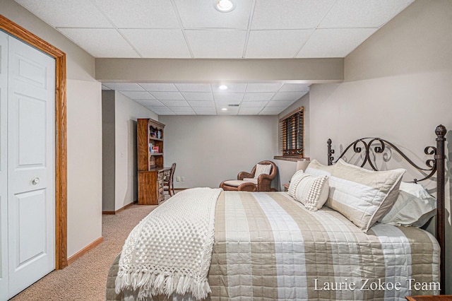 bedroom with recessed lighting, light colored carpet, baseboards, and a paneled ceiling