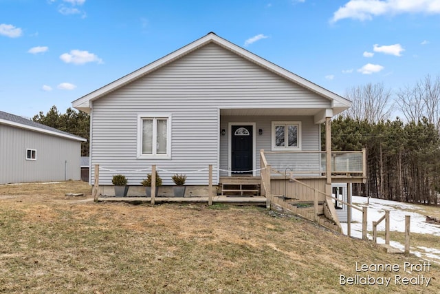 bungalow-style home with a front yard