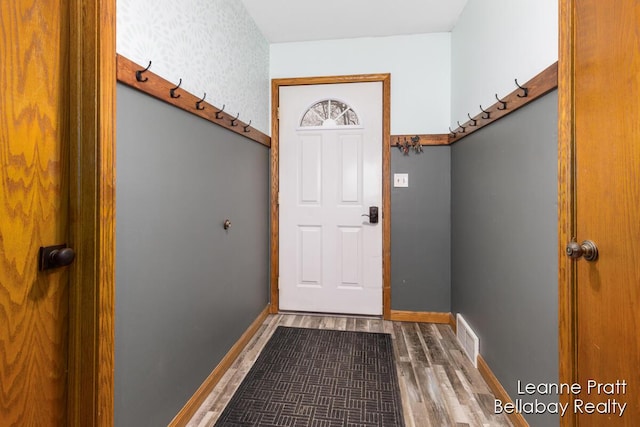 entryway with visible vents, baseboards, and wood finished floors