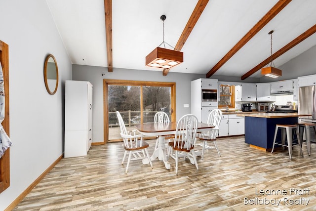 dining area with light wood-style flooring, vaulted ceiling with beams, and baseboards