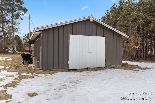 snow covered structure featuring an outdoor structure