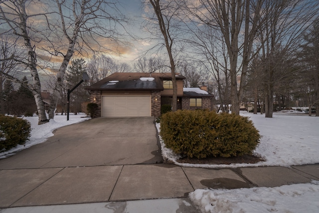 view of front of house featuring a garage, concrete driveway, and a chimney