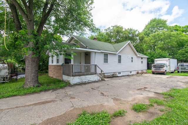 view of front of home featuring a porch and a chimney