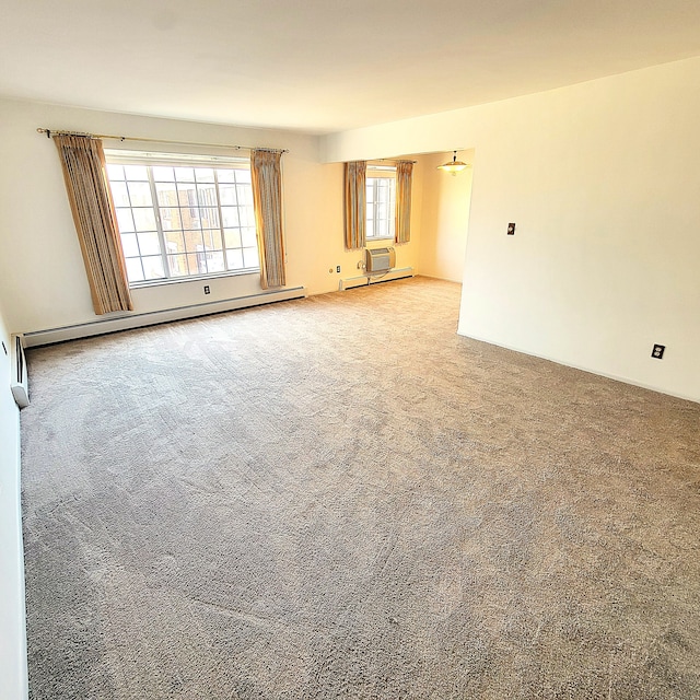 carpeted empty room with a baseboard radiator