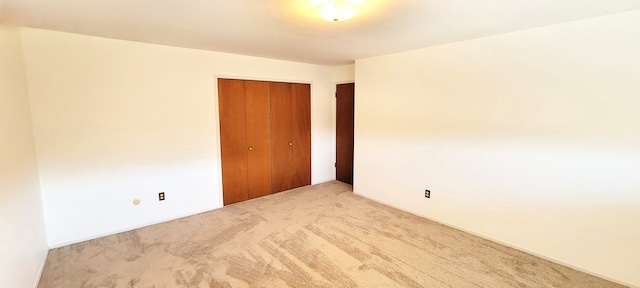 unfurnished room featuring light colored carpet