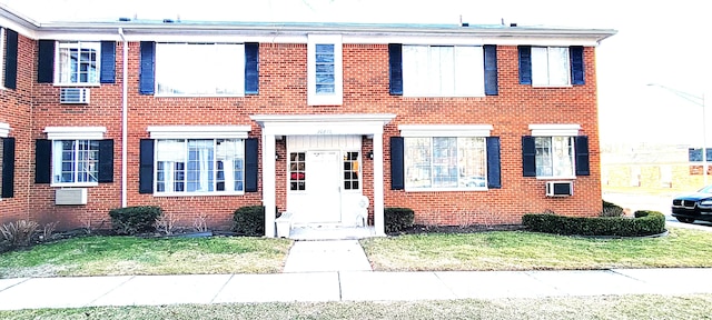 view of front of home with brick siding and a front lawn