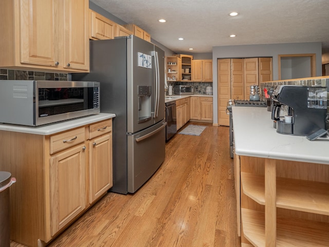 kitchen with light wood-style flooring, light brown cabinetry, open shelves, backsplash, and appliances with stainless steel finishes