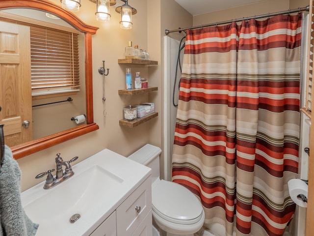 bathroom featuring a shower with shower curtain, toilet, and vanity