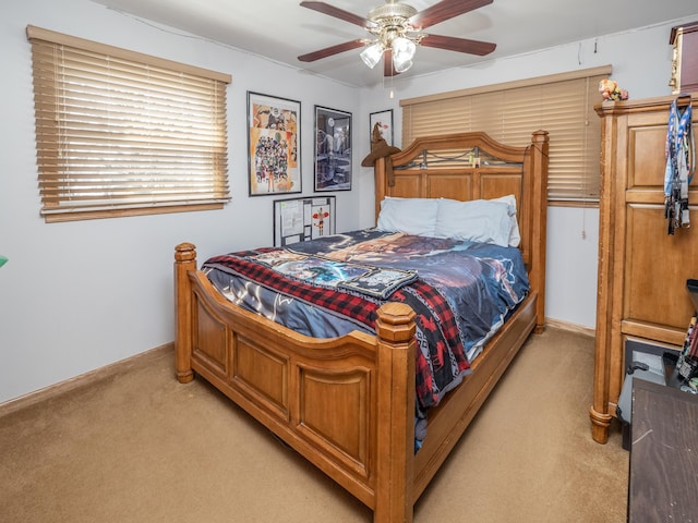 bedroom with ceiling fan, baseboards, and light carpet