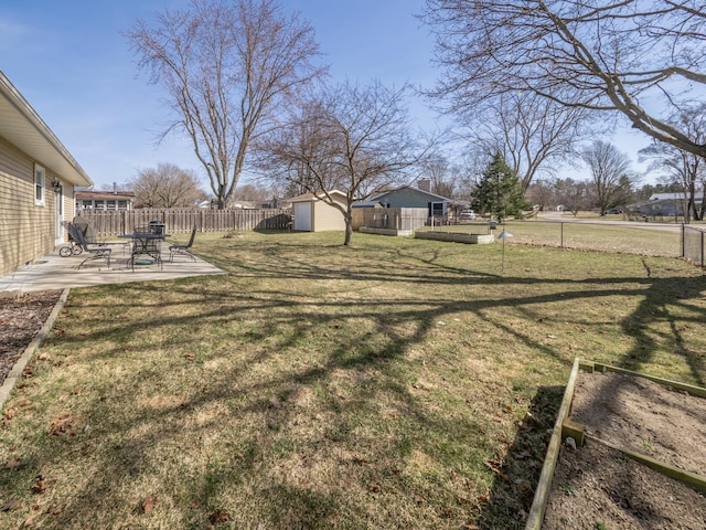 view of yard featuring a patio area, a shed, an outdoor structure, and a fenced backyard