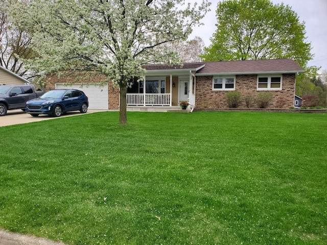 single story home featuring brick siding, a front lawn, covered porch, a garage, and driveway