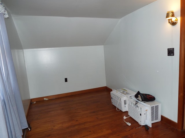 bonus room with lofted ceiling, wood finished floors, and baseboards