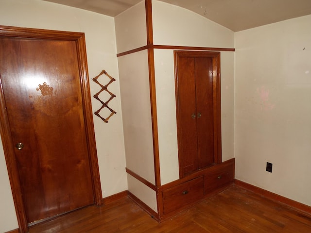 unfurnished bedroom featuring baseboards and wood finished floors