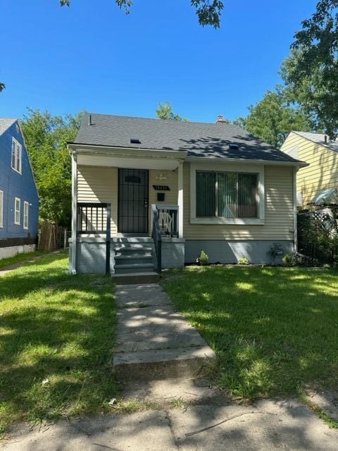 18635 Dale St, Detroit, MI 48219 - bungalow with a front lawn, covered porch, and roof with shingles