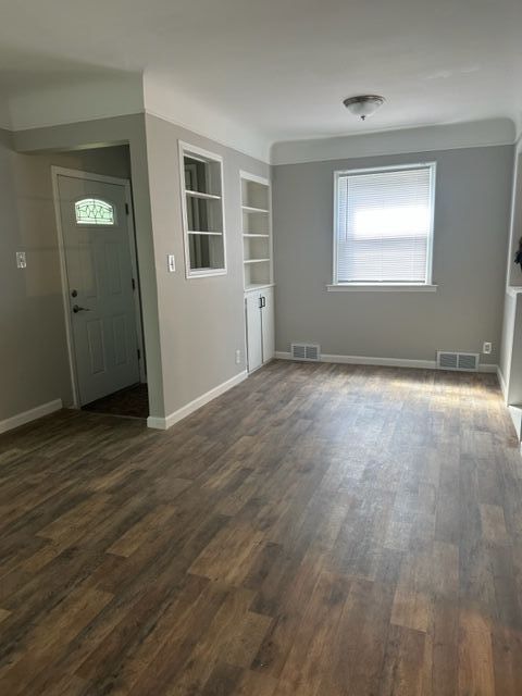 18635 Dale St, Detroit, MI 48219 - unfurnished room with baseboards, visible vents, and dark wood-style flooring