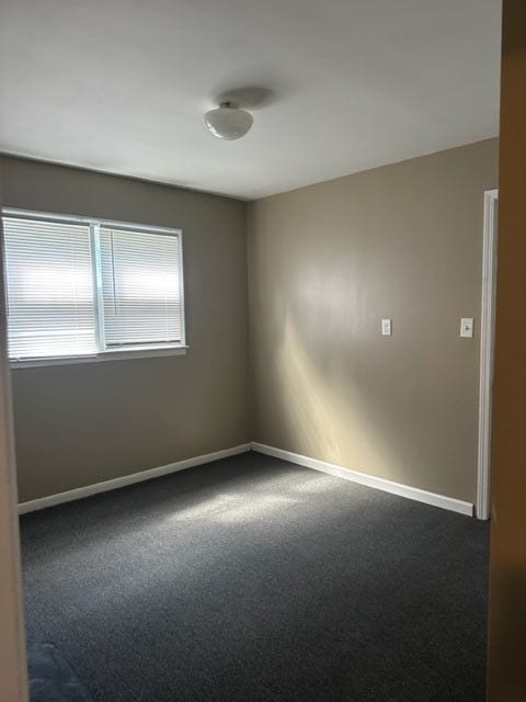 18635 Dale St, Detroit, MI 48219 - empty room featuring baseboards and dark colored carpet