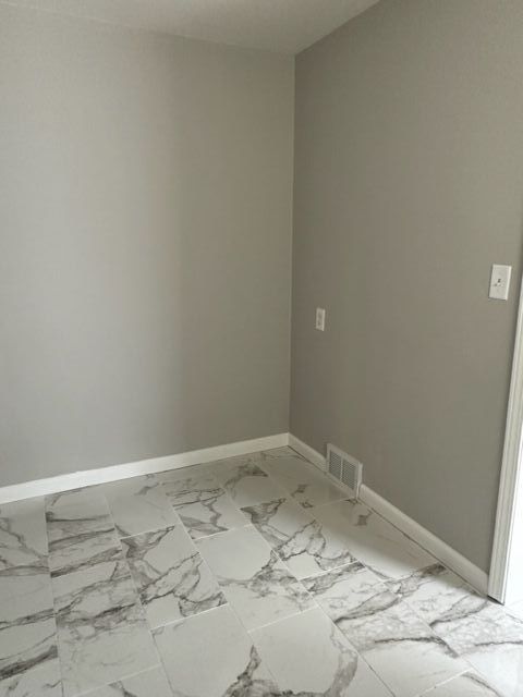 18635 Dale St, Detroit, MI 48219 - empty room with marble finish floor, baseboards, and visible vents