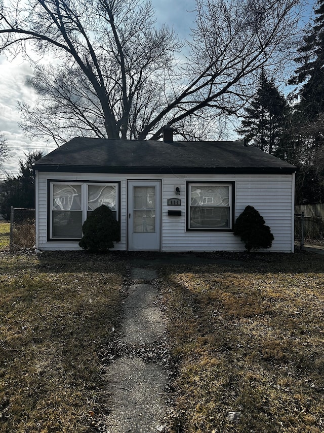 view of front of home featuring fence and a chimney